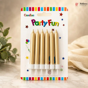 Pack of gold candles with 'Party Fun' packaging on a wooden surface.