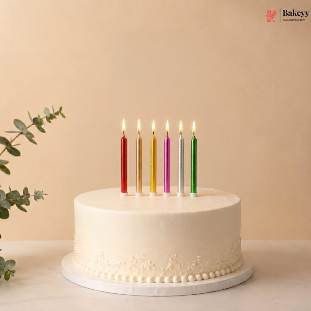White cake with colorful candles on a beige background, featuring the Bakey brand.