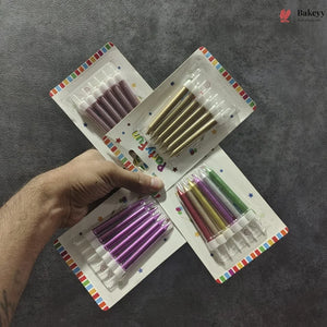 Set of colorful birthday candles in packaging held by a hand on a gray background
