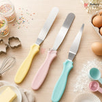 Three spatulas with pastel handles on a baking-themed background