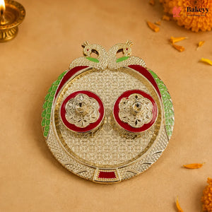 Decorative item with gold, red, and green colors on a beige background