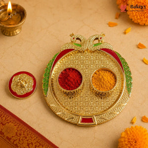 Decorative gold tray with red and yellow powders on a beige background with marigold flowers and a lit candle.