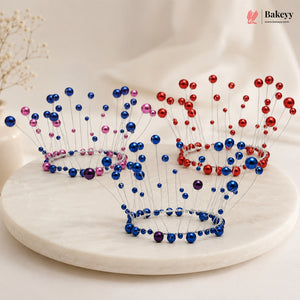 Two decorative tiaras with blue, red, and pink beads on a white surface.