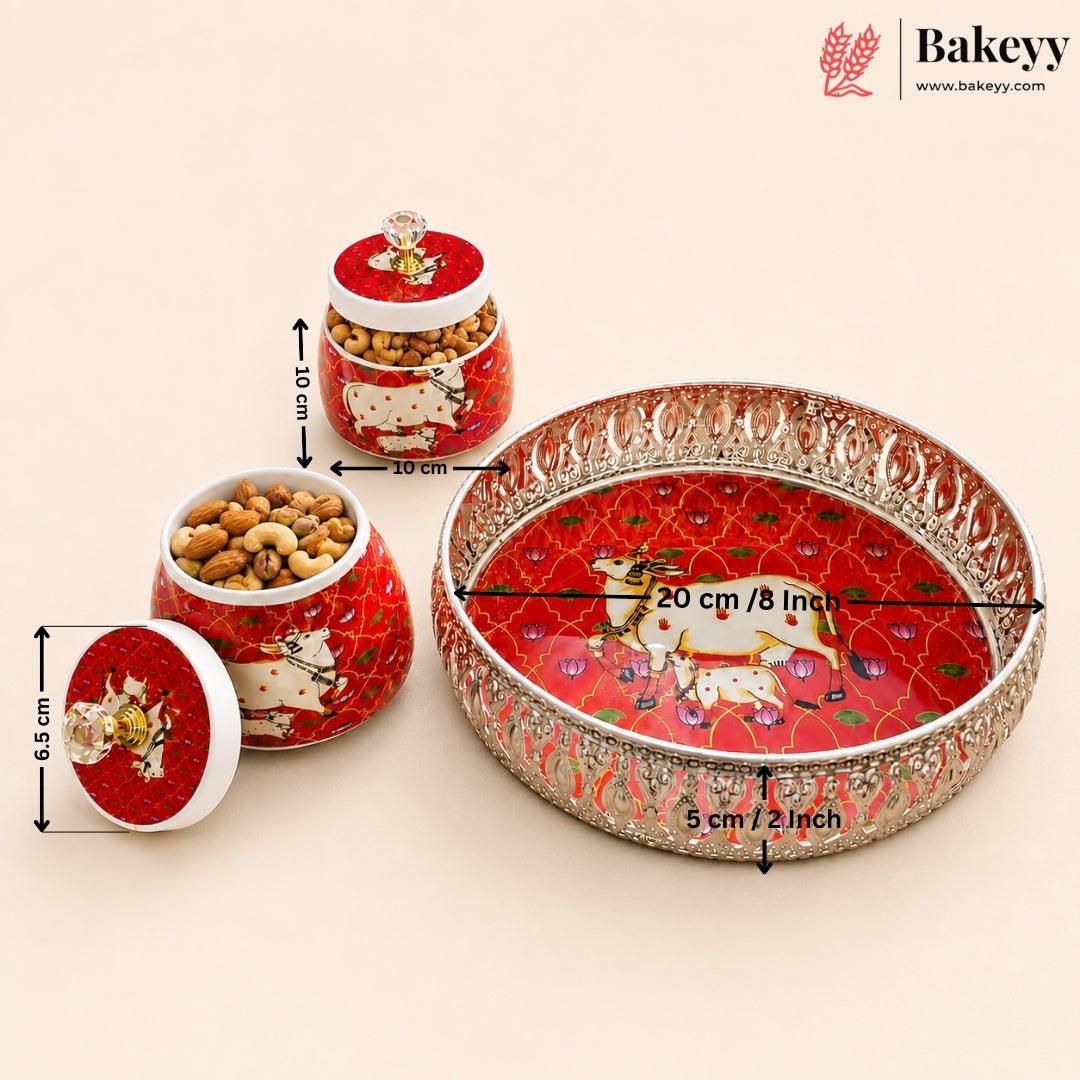 A set of red and gold decorative Indian-style ceramic jars and a matching serving tray with animal illustrations, shown on a beige background with overlaid dimensions and the Bakeyy brand logo.