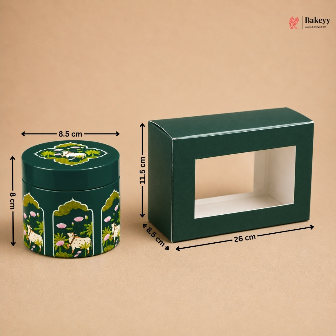 A dark green rectangular display box with a front window and a matching round decorative tin with animal and floral illustrations, shown on a beige background with dimension arrows and labels.