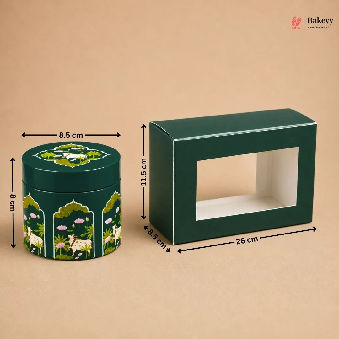 A dark green rectangular display box with a front window and a matching round decorative tin with animal and floral illustrations, shown on a beige background with dimension arrows and labels.