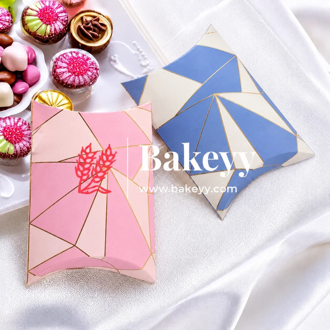 Geometric patterned boxes with 'Bakeyv' branding on a white surface with pastries in the background.