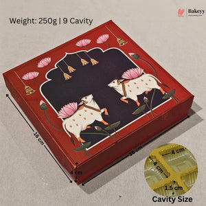 A red rectangular bakery box with traditional Indian-style artwork of two white cows with pink lotus flowers, shown on a light beige fabric background. Black dimension lines and text indicate measurements: 16 cm by 16 cm with a 4 cm height, plus a circular inset showing the cavity size as 4 cm by 4 cm by 1.
