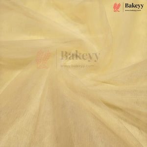 A close-up of draped pale yellow fabric with a soft, semi-sheer texture and visible weave, featuring a Bakeyy watermark logo in the center and top right corner.