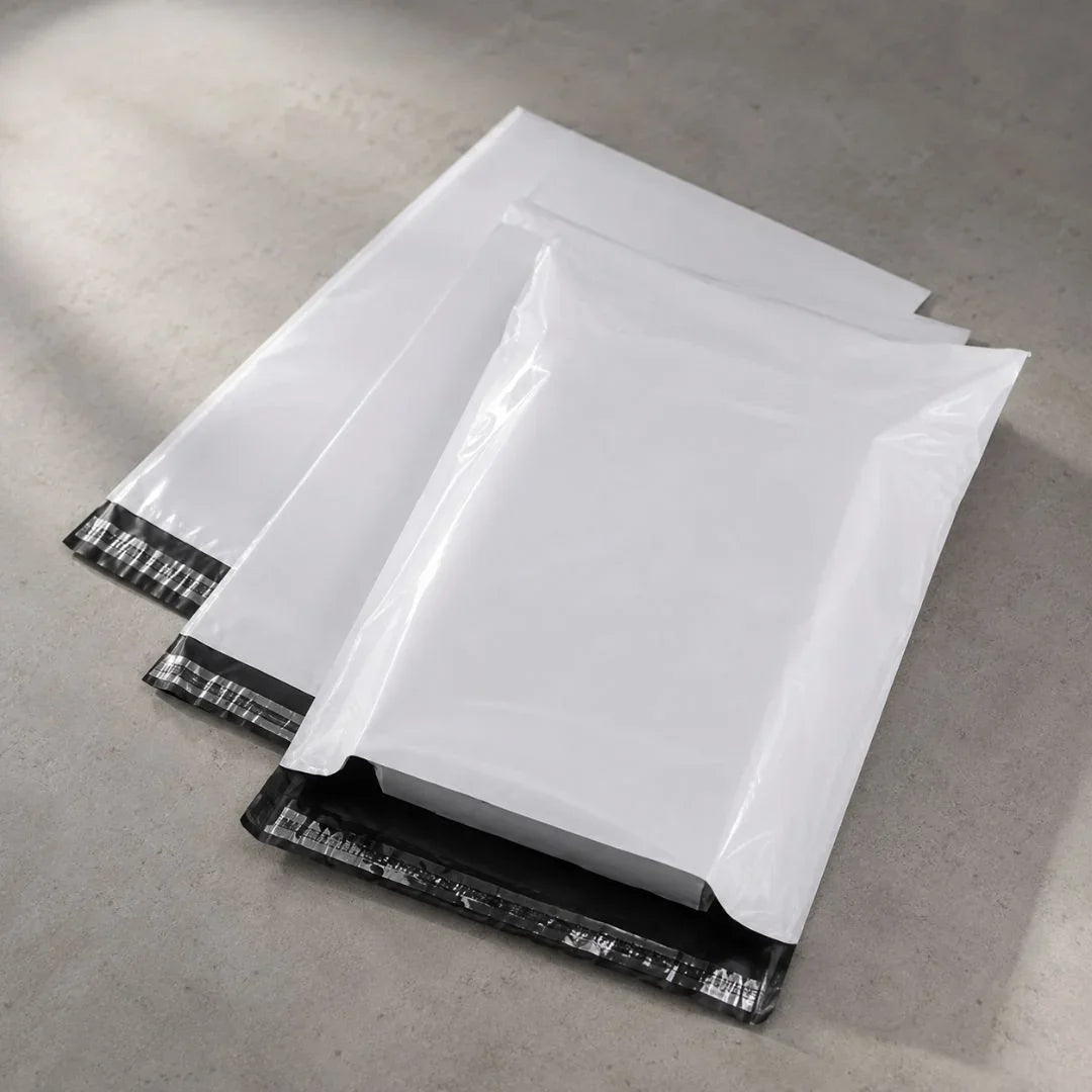 White mail envelopes with black sealing strips on a gray surface