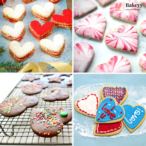 Four-panel collage of heart-shaped decorated cookies: white and red jam sandwich cookies, pink and red swirled cookies, chocolate chip cookies with sprinkles on a cooling rack, and blue/red heart-shaped iced cookies on a powdered surface. A Bakeey logo appears in the top right.