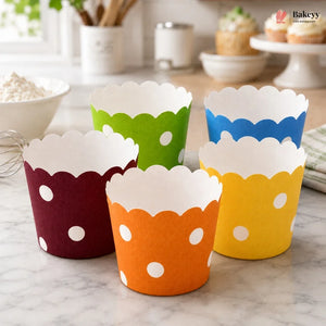 Colorful cupcake liners with polka dots on a kitchen counter.