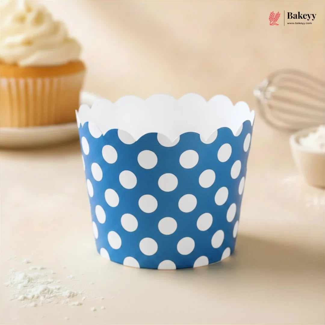 Blue polka dot cupcake wrapper on a light surface with a blurred background