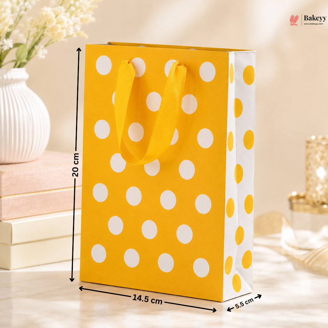 Yellow gift bag with white polka dots and measurements on a blurred background