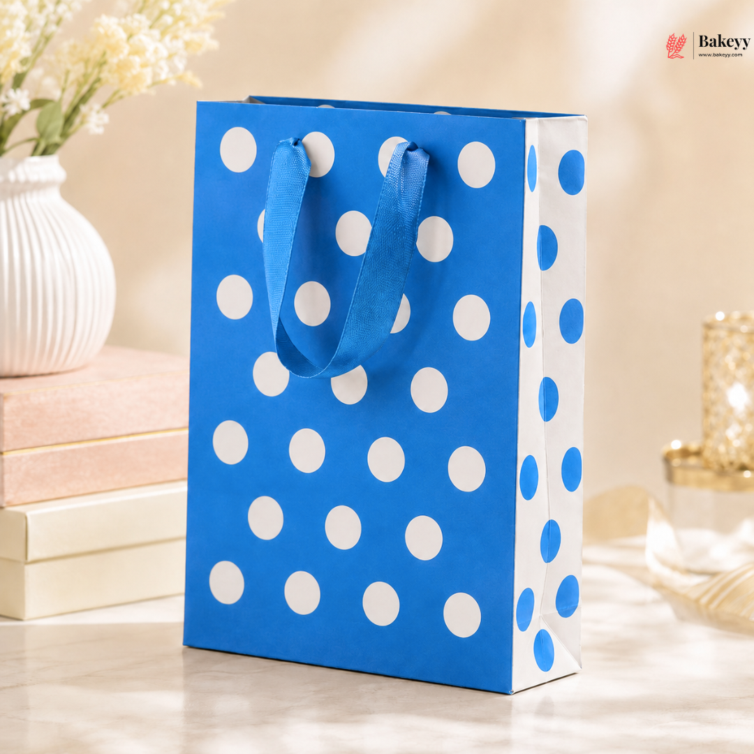 Blue gift bag with white polka dots on a decorative background