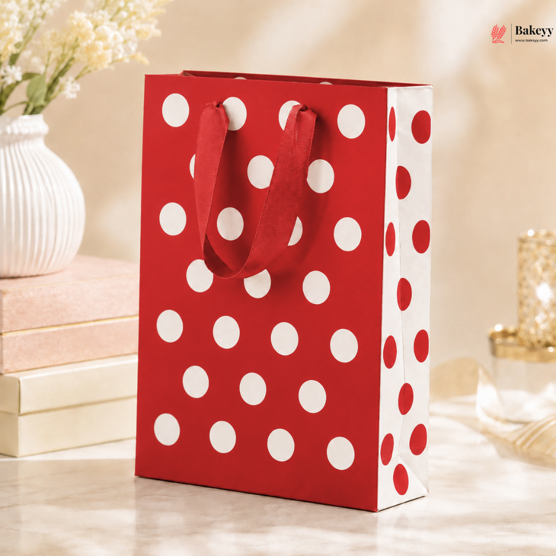 Red and white polka dot gift bag on a blurred background