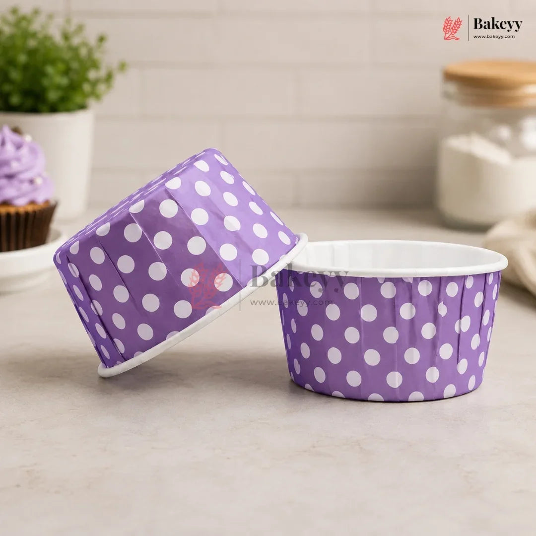 Purple polka dot baking cups with a lid on a neutral background, featuring the Bakey brand.