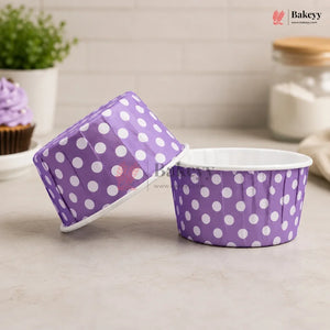 Purple polka dot baking cups with a lid on a neutral background, featuring the Bakey brand.