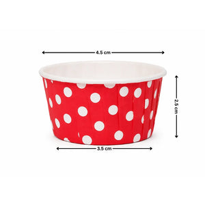 Red paper cup with white polka dots and measurements on a white background