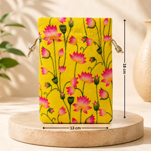 Floral-patterned pouch on a wooden stand with measurements, against a neutral background.