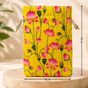 Yellow pouch with pink floral pattern on a wooden stand with measurements indicated.