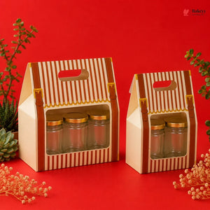 Two cardboard gift boxes with glass jars on a red background