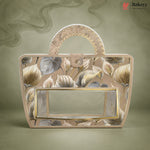A decorative handbag with a floral pattern in beige, gray, and gold, featuring a clear front window and a curved top handle, set against a matching textured background. The Bakeyy brand logo is visible in the top right corner.