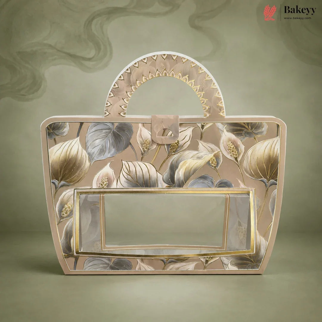 A decorative handbag with a floral pattern in beige, gray, and gold, featuring a clear front window and a curved top handle, set against a matching textured background. The Bakeyy brand logo is visible in the top right corner.
