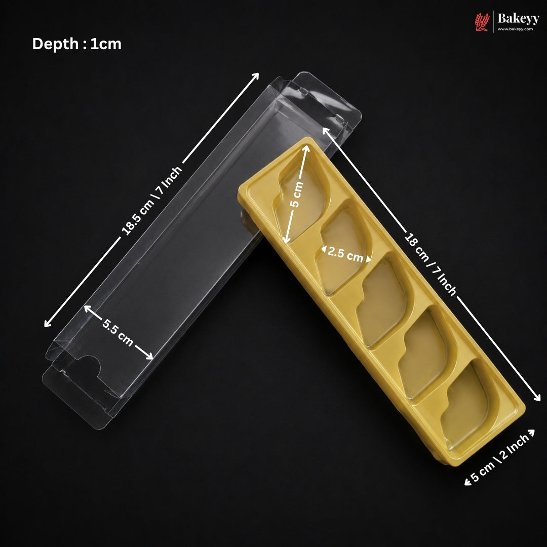 A clear plastic pastry tray shown with overlaid dimension arrows and text indicating depth and measurements, on a black background. A yellow insert tray with four compartments is placed beside it for scale/context.