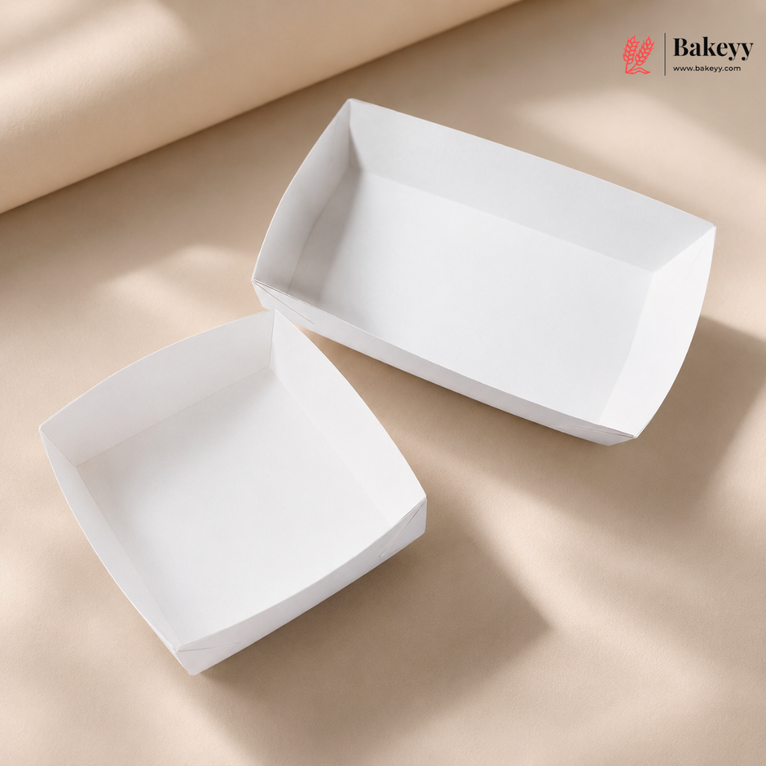 Two white ceramic bowls on a beige surface with 'Bakeyy' branding.