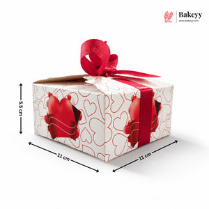 Gift box with red ribbon and heart designs, dimensions shown, on a white background