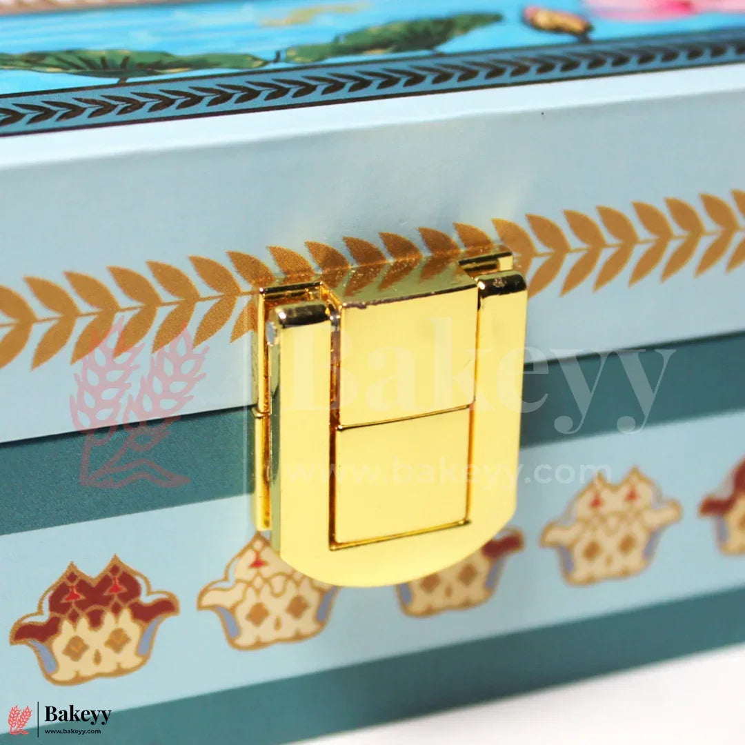 Gold latch on a decorative box with floral patterns