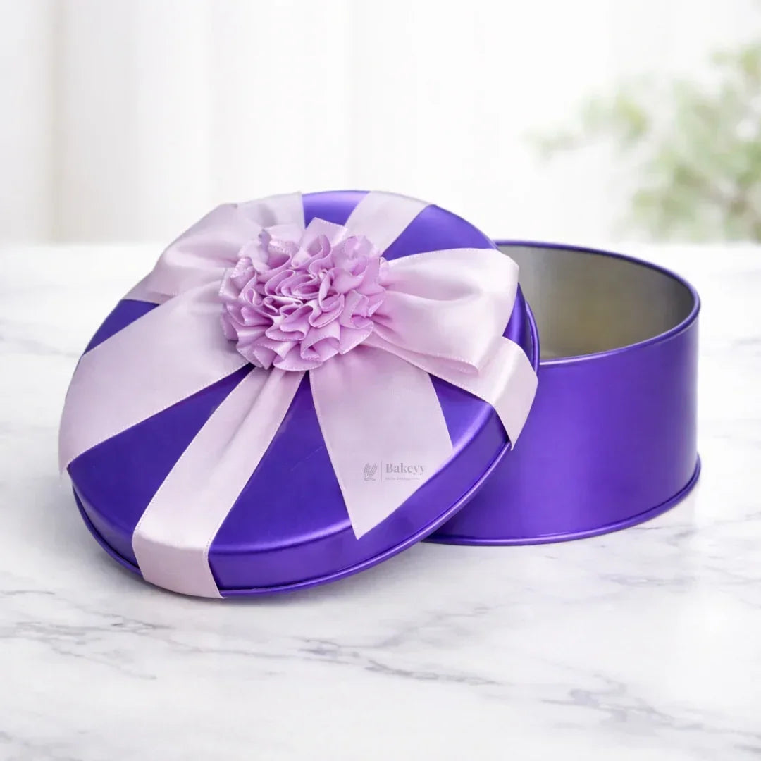 Purple round tin box with pink ribbon and flower, gift packaging from Bakeyy.com