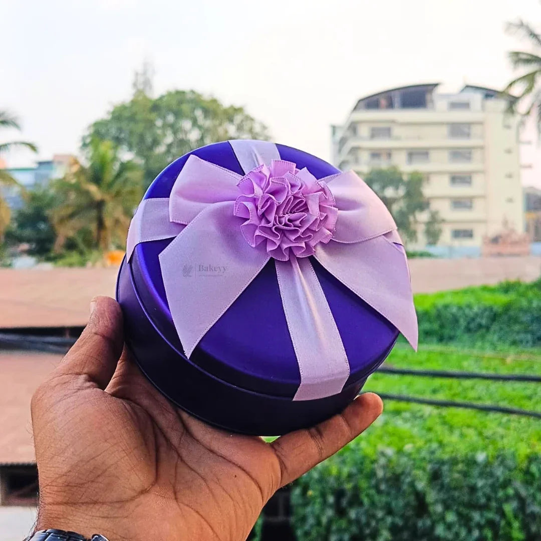 Purple round tin gift box with pink ribbon, Bakeyy gift packaging for hampers and bakery gifts