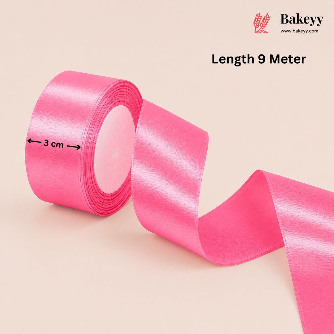 Pink ribbon with measurement details on a beige background, featuring the Bakeyy brand.