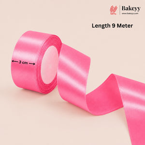 Pink ribbon with measurement details on a beige background, featuring the Bakeyy brand.