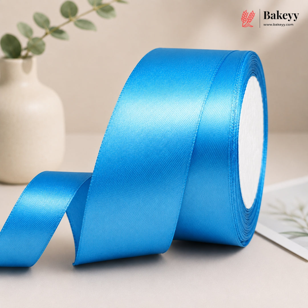 Roll of blue satin ribbon with a beige background and 'Bakeyy' branding.