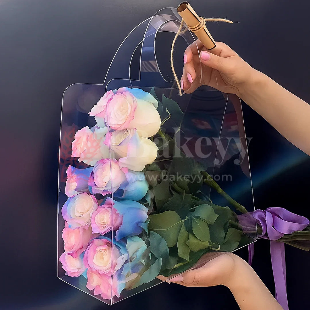 Transparent bag with colorful roses and green leaves held by a hand against a dark background.