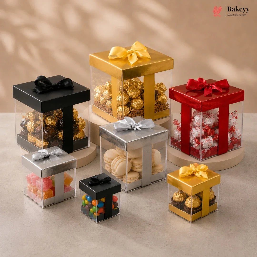 Collection of gift boxes with various candies and bows on a neutral background