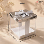 Small clear cake stand with silver bow and dimensions on a beige background