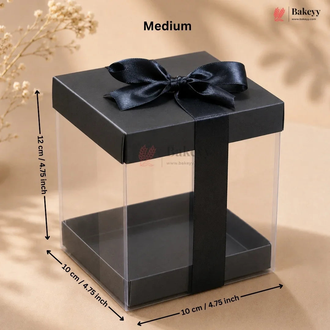 Black gift box with a bow and measurements on a beige background