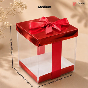 Clear gift box with red ribbon and dimensions on a beige background