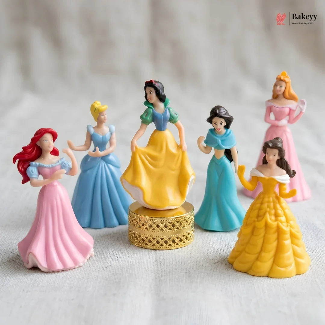 Set of six princess figurines in colorful dresses on a neutral background