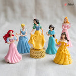 Set of six princess figurines in colorful dresses on a neutral background