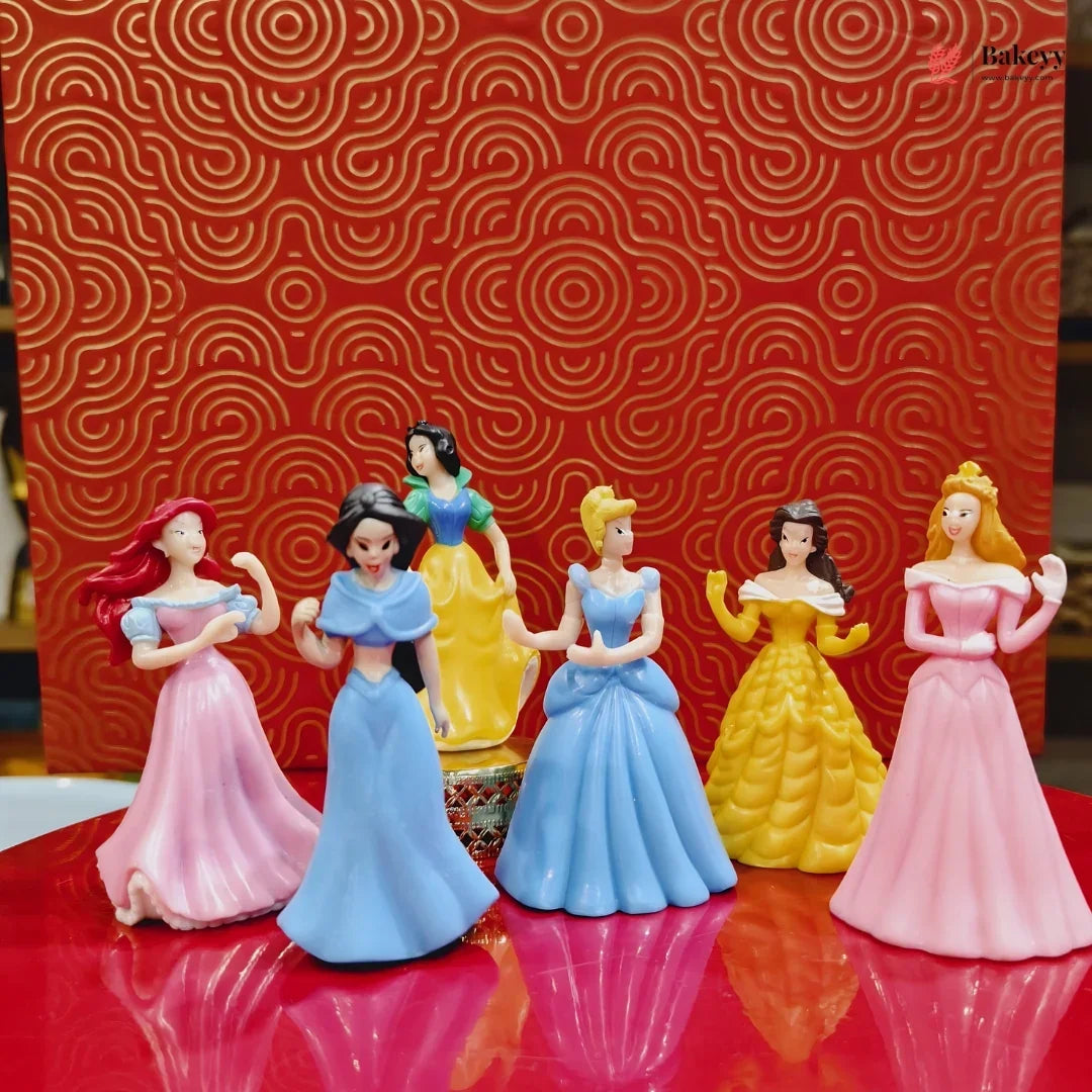 Set of princess figurines on a red surface with a patterned red background