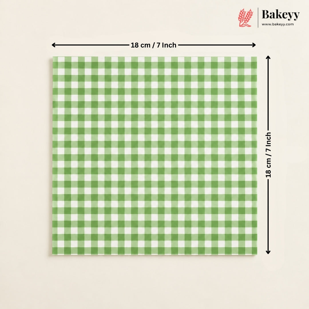 A square green and white gingham checkered tile or mat shown on a light beige background, with black dimension arrows indicating 18 cm by 18 cm (7 inches) and a Bakeey logo in the top right corner.