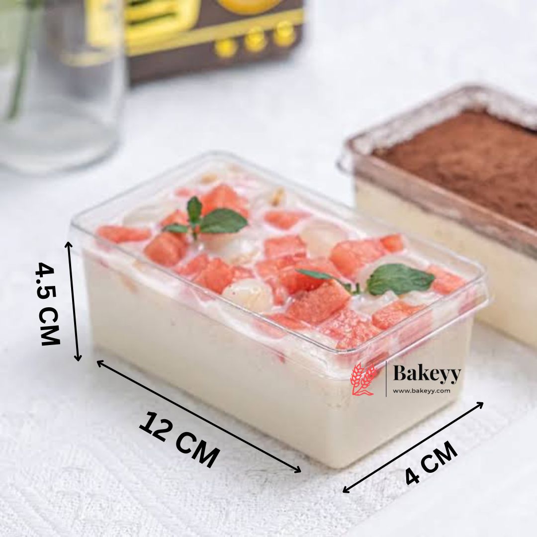 Rectangular cake with fruit toppings in a clear container, dimensions shown, with Bakeyy logo.