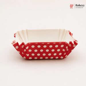 Rectangular baking tray with red polka dot pattern on a white background, branded 'Bakeyy'.