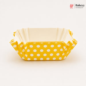 Yellow polka dot baking tray with beige interior on a white background, featuring the Bakeyy brand.