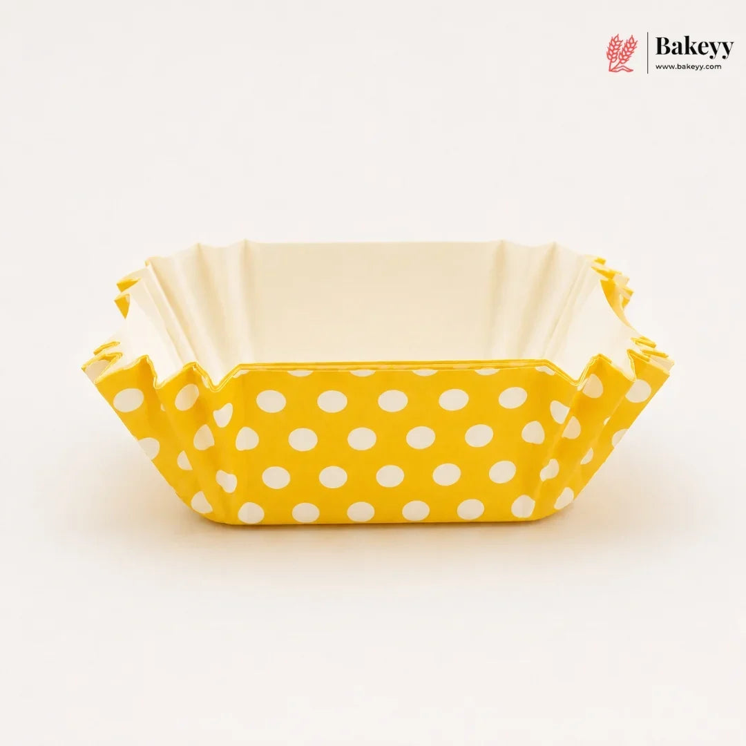 Yellow polka dot baking tray with beige interior on a white background, featuring the Bakeyy brand.